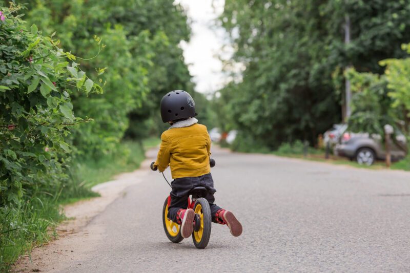 A child on a balance bike in a park