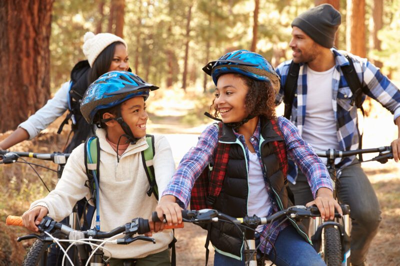 A family on their cycles in the woods