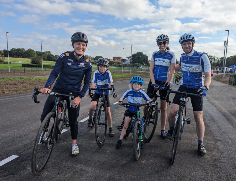 The Tranter family on their bikes. They are wearing matching blue tops.