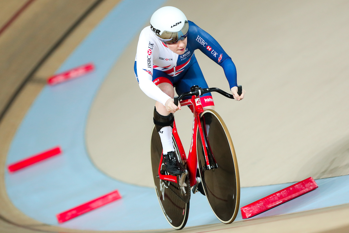 Megan Giglia cycling in the Rio Paralympics. She is on a track bike in a velodrome