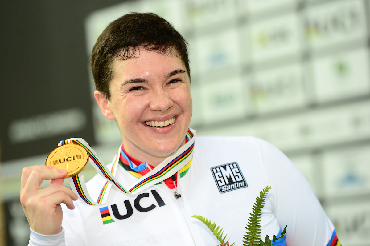 Megan Giglia holding up her gold medal from the Rio Paralympics