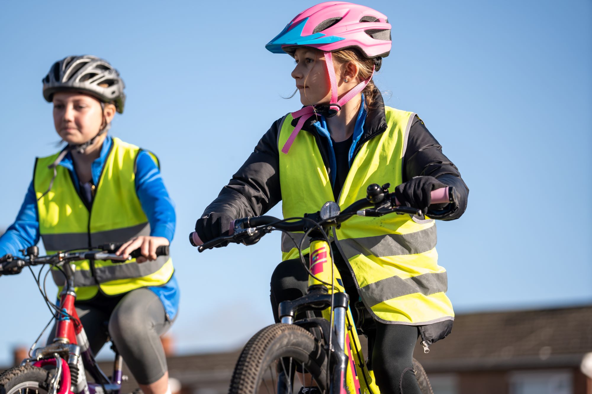 A girl riding on her bike. She has a bell on her handlebars