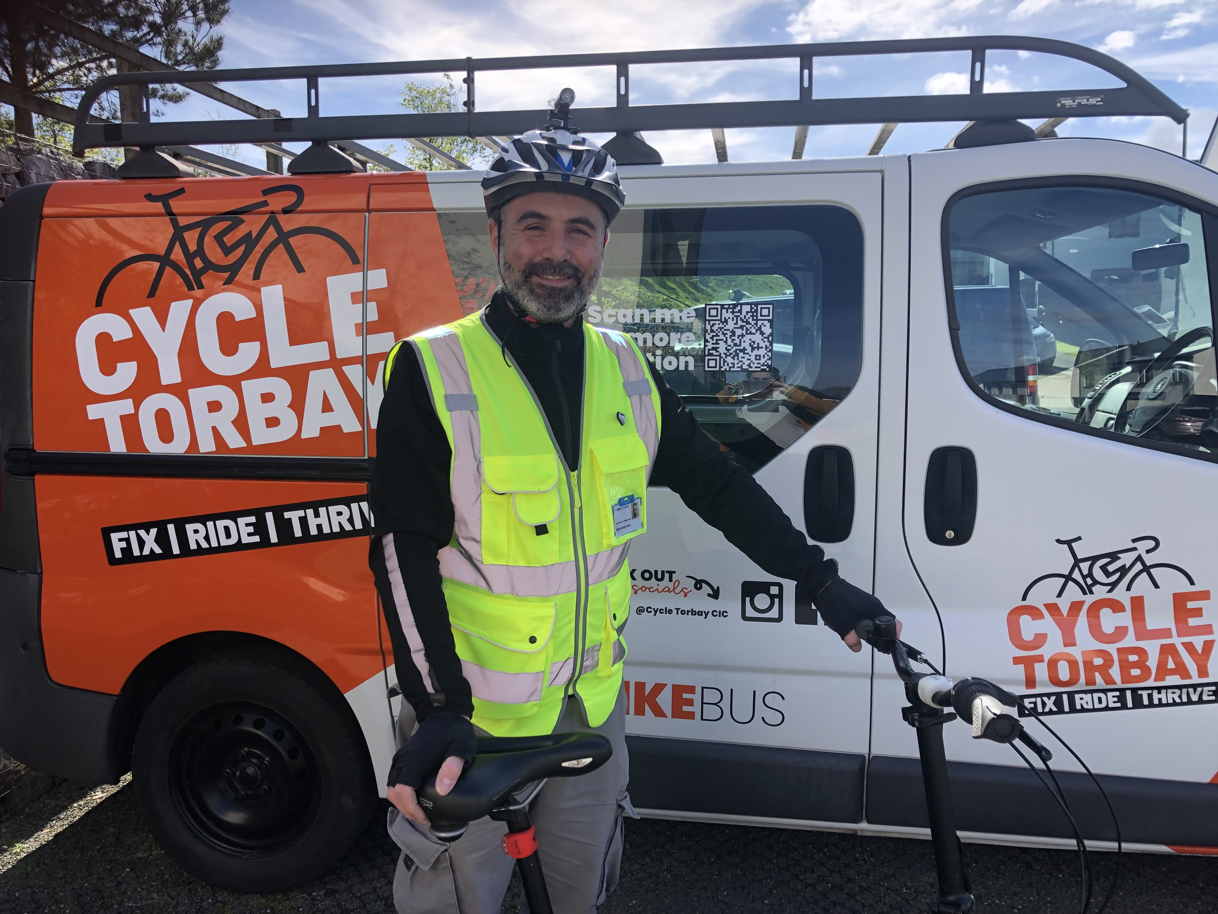 Instructor Jon standing with his bike in front of the Cycle Torbay bike bus