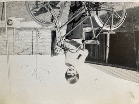 A black and white photograph of Jenny aged 7 with her bicycle