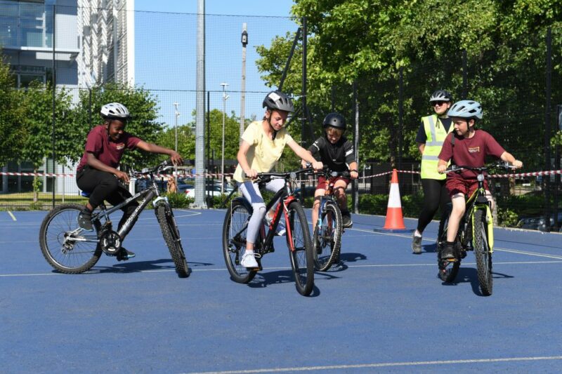 Children on their cycles taking part in the Bikeability Olympics