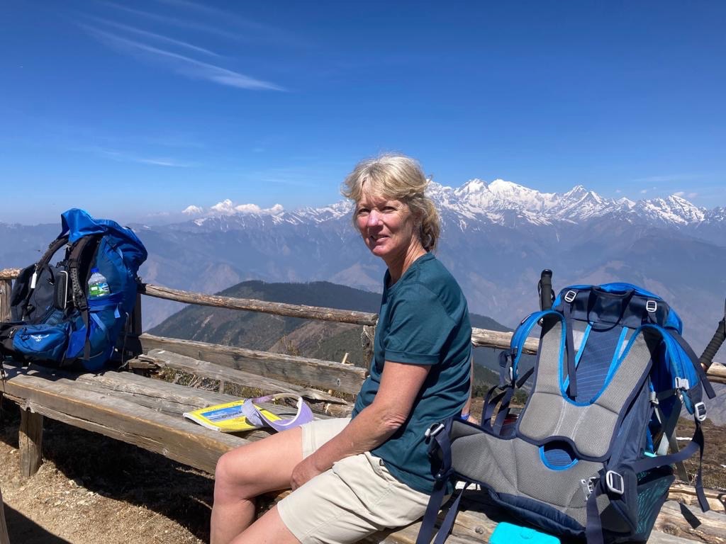 Jenny looking over a valley surrounded with blue skies