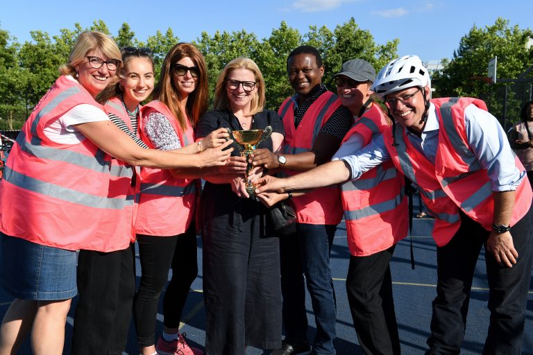 People from local businesses with the trophy