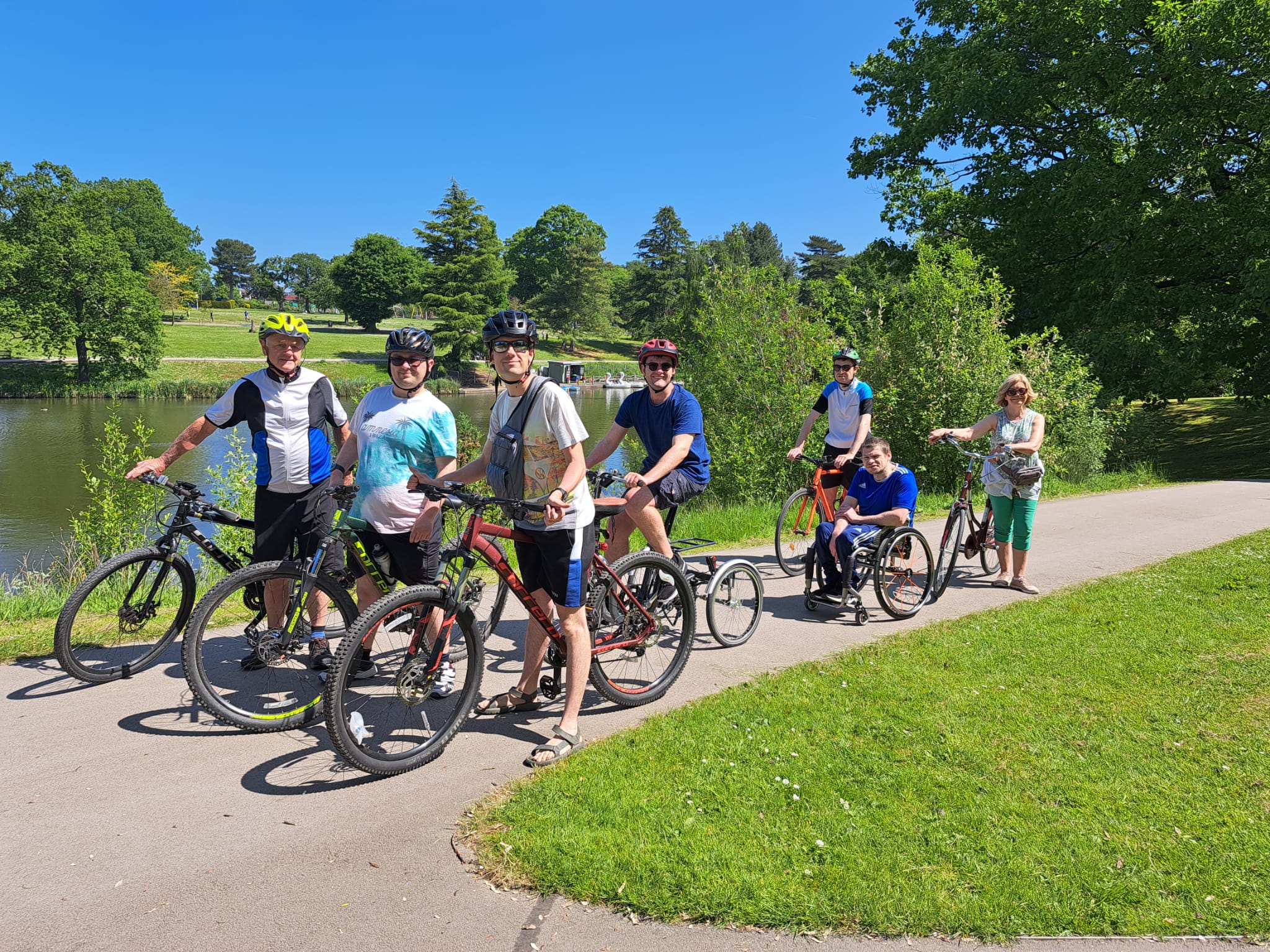 Gareth and other cyclists stopping for a break and a photo in a park