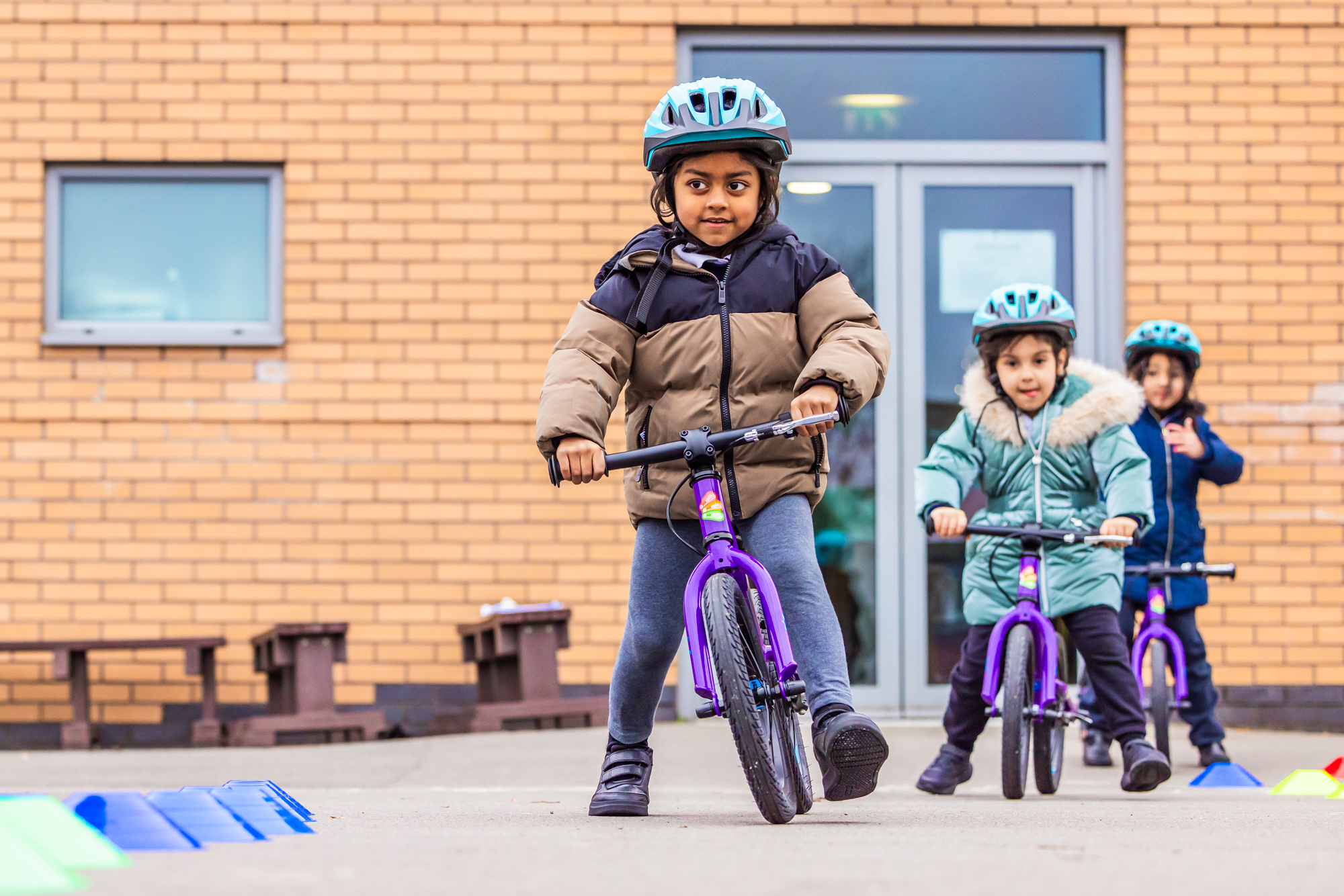 Children on balance bikes in the playground