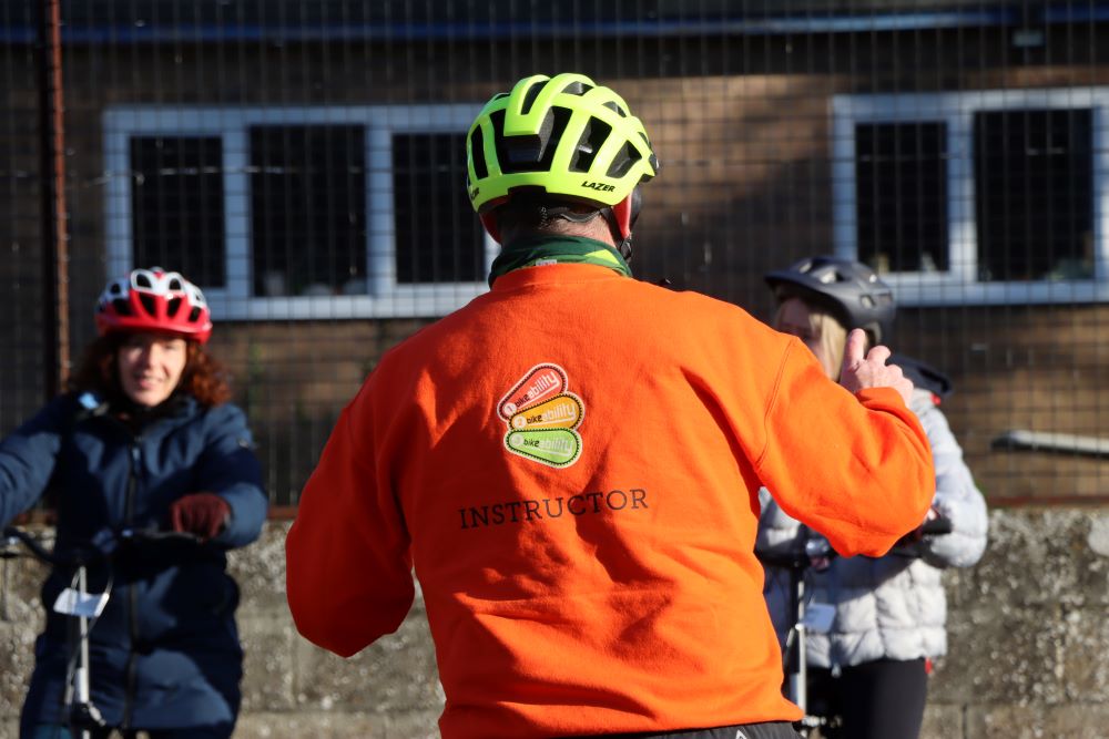 Bikeability instructor giving instructions to riders in playground